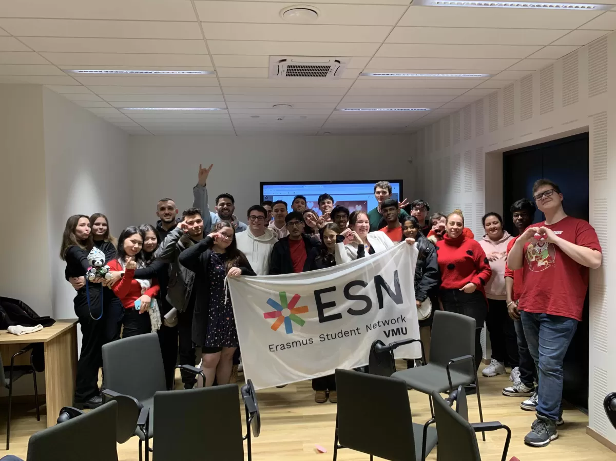 participants standing together, holding up the ESN VMU flag