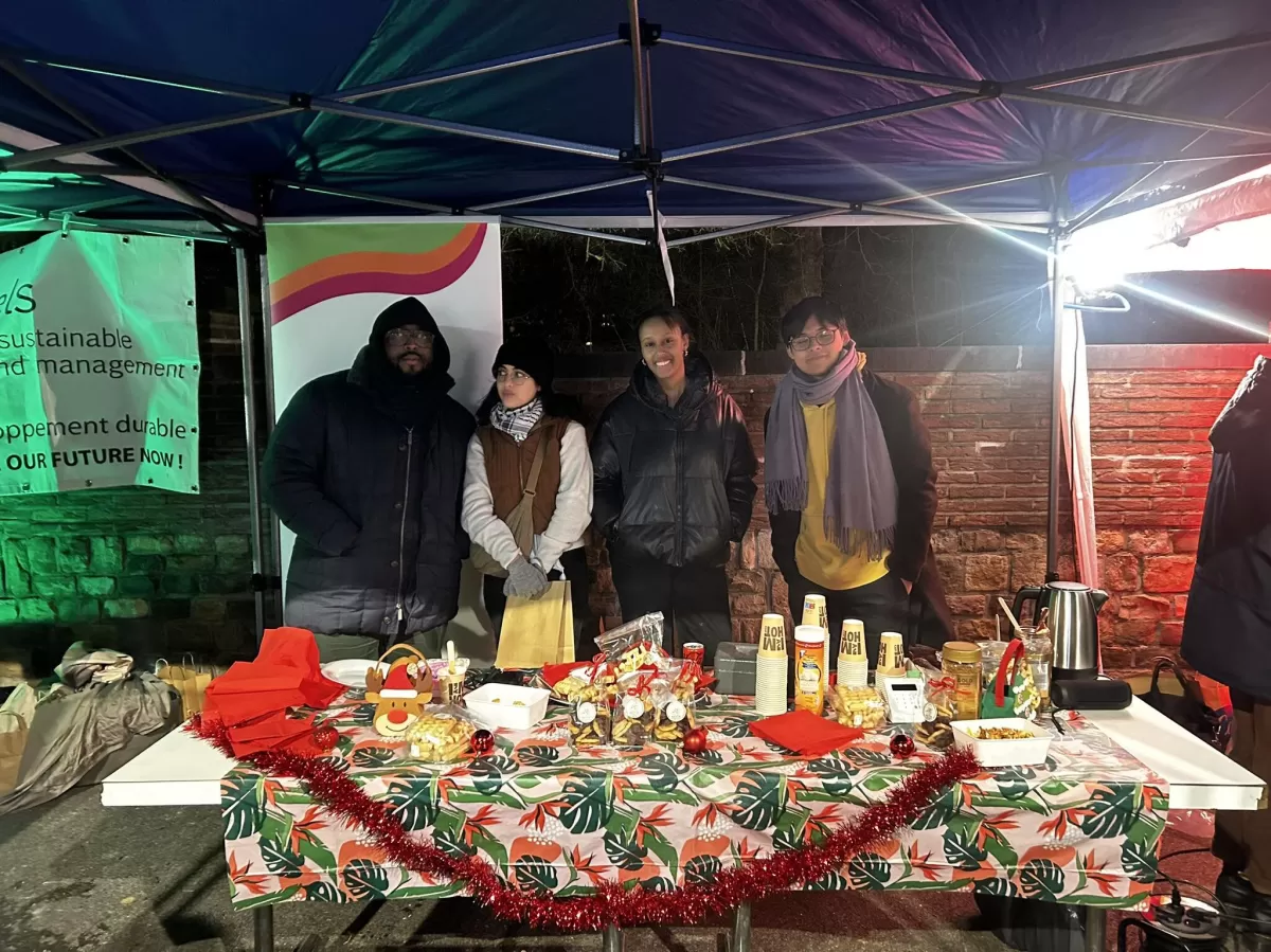 ESN Members behind a decorated food stand