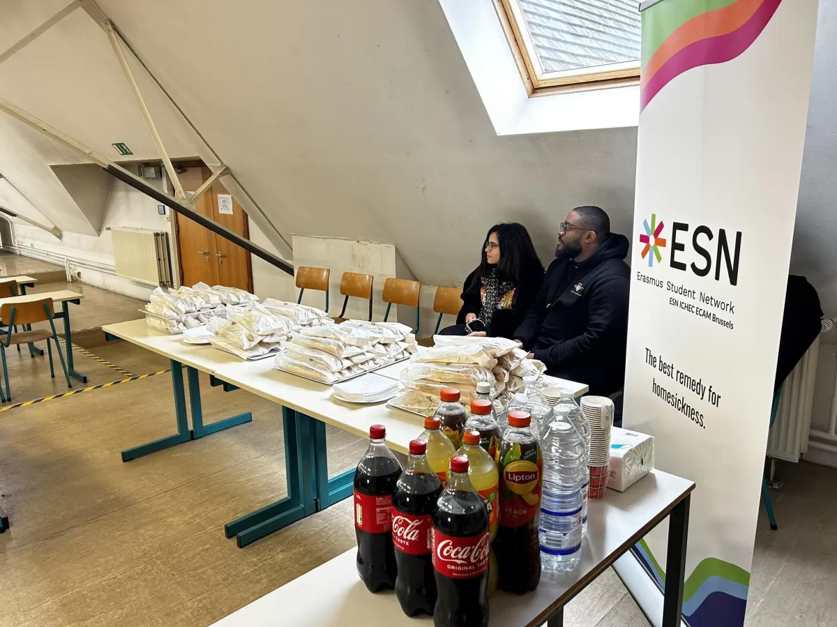 ESN Members sitting behind a food stand and looking away