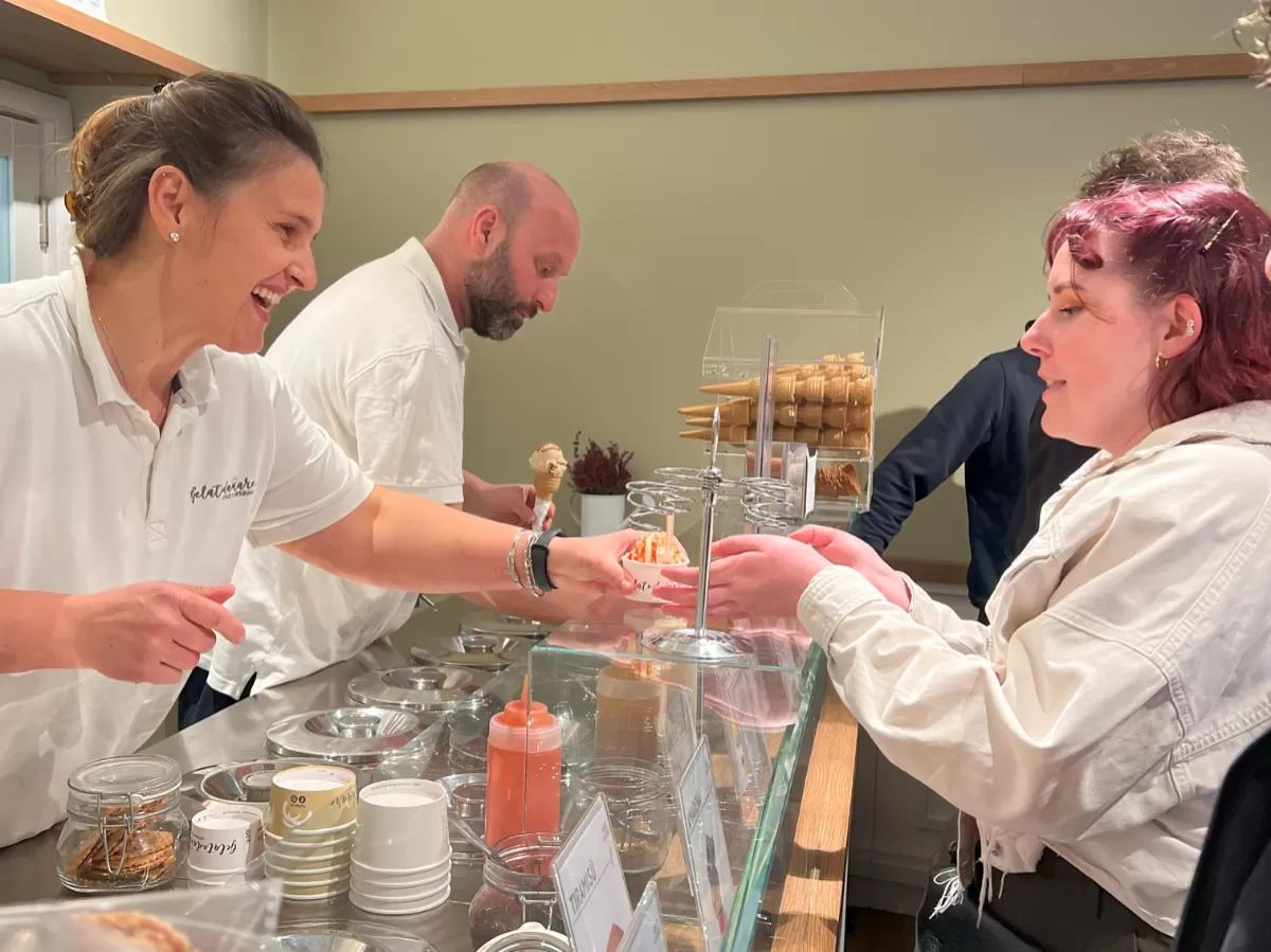 The owner of Gelatodamare giving a cup of gelato to one of the participants.