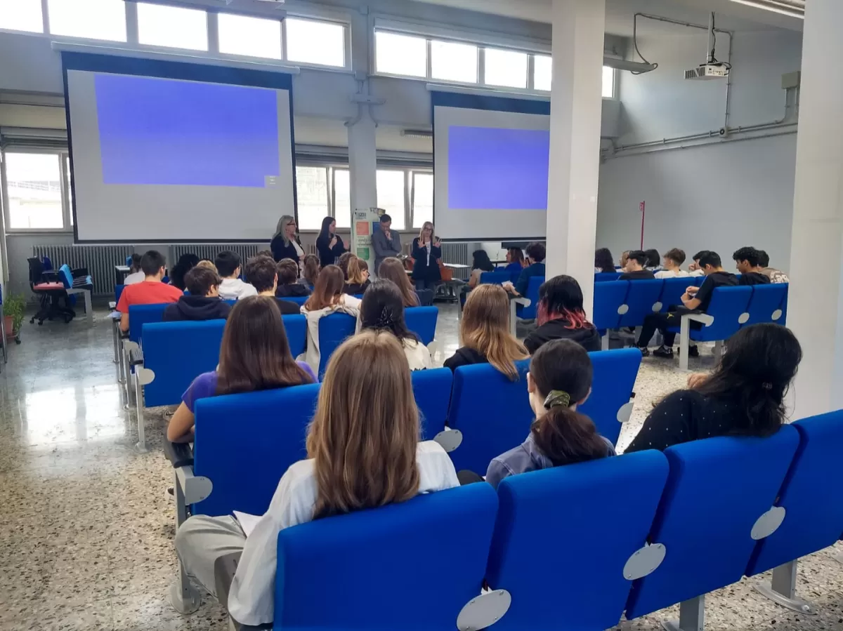 Volunteer talking to school pupils