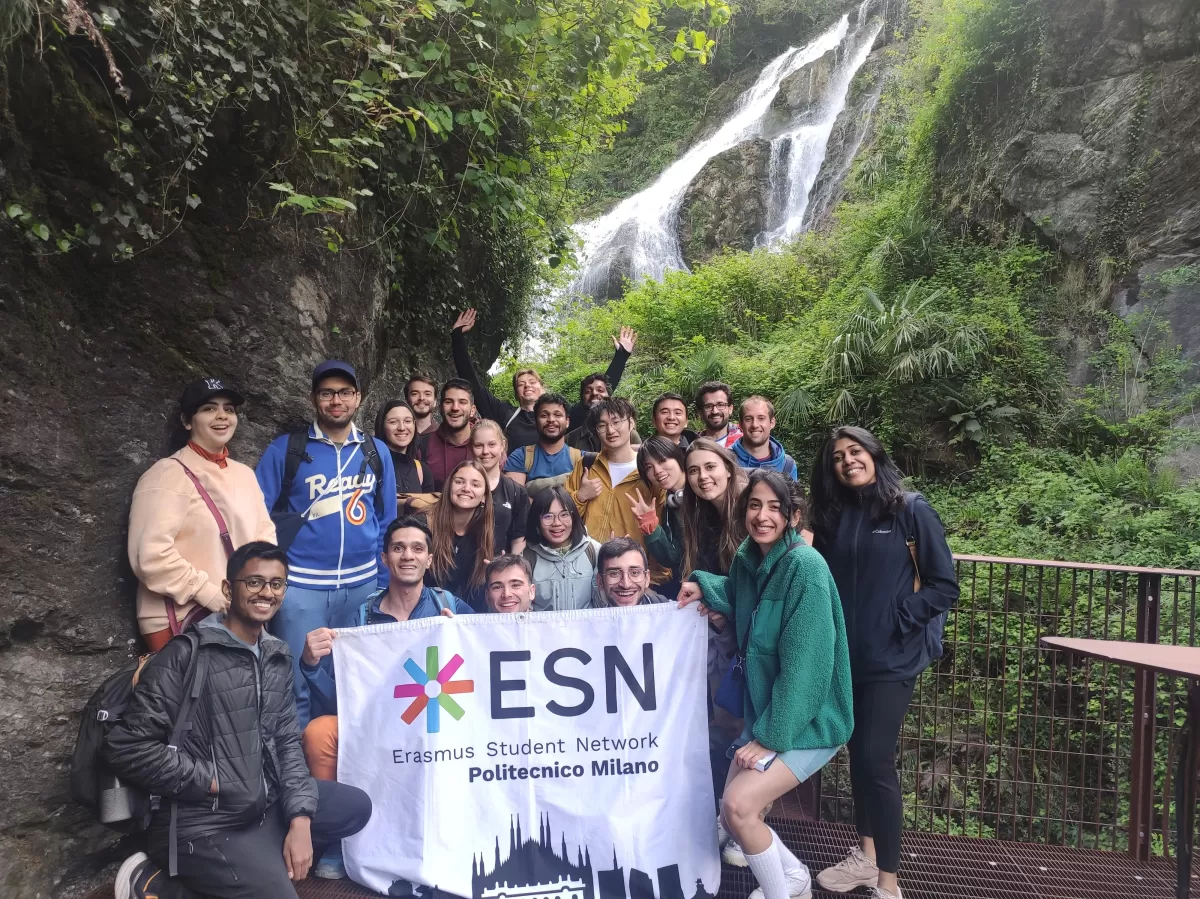 The group with the ESN flag and a waterfall in the background