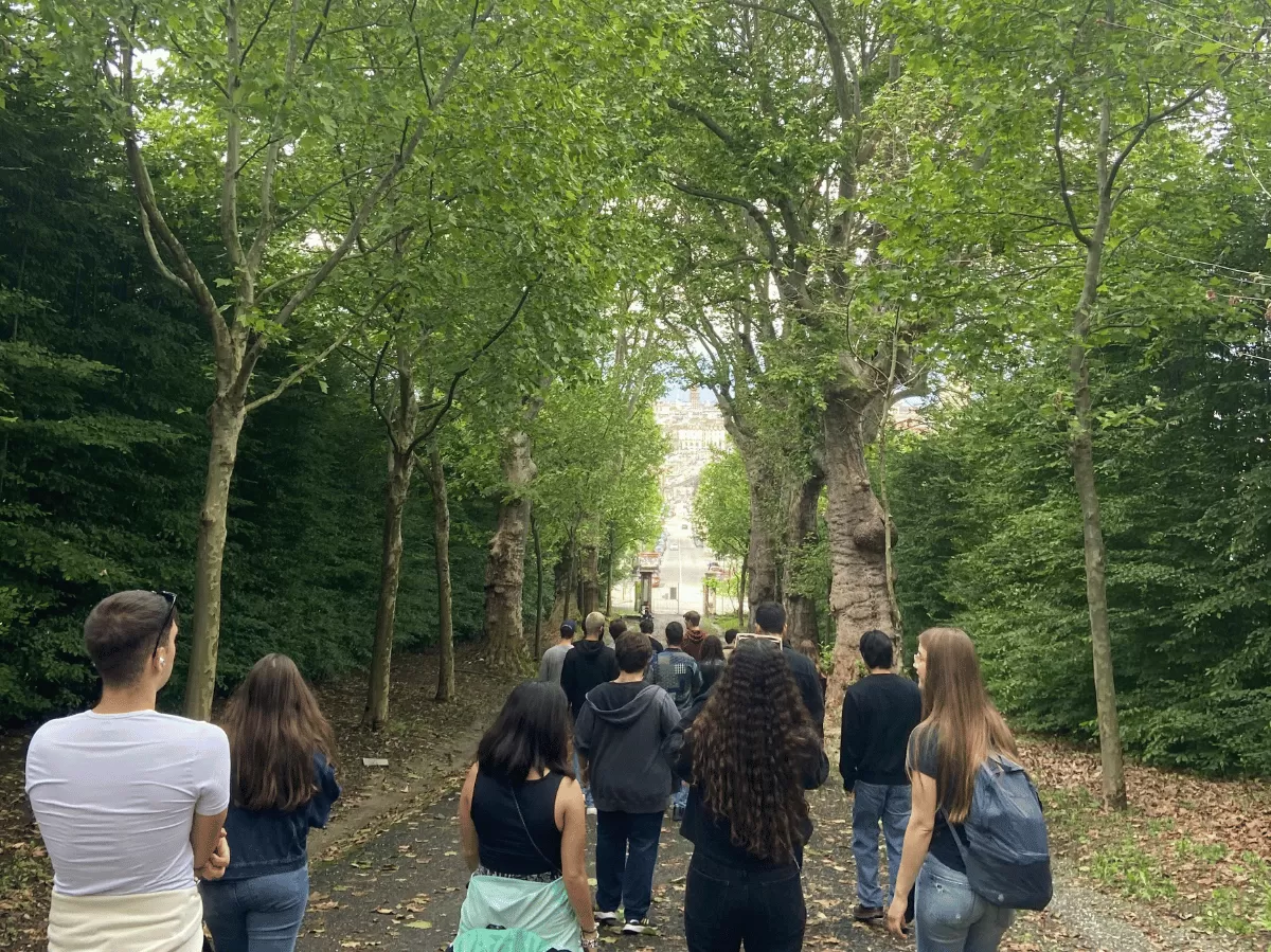 Group of international students walking through the garden of the villa