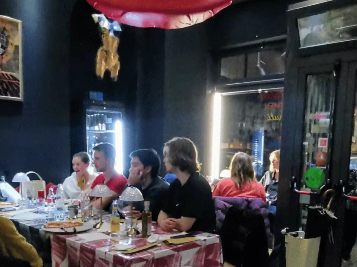 group of students sitting in the pizzeria