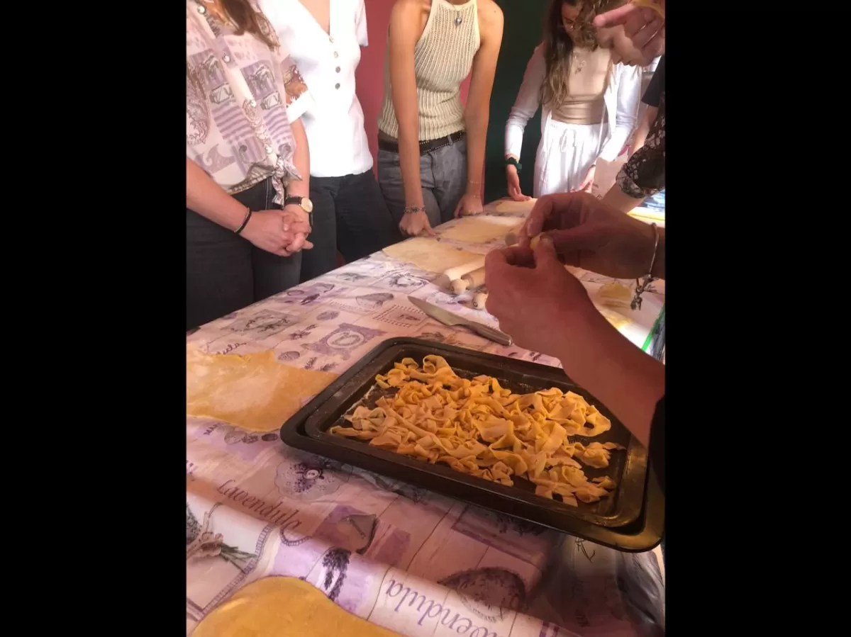 Chef explaining to students how to cut the pasta