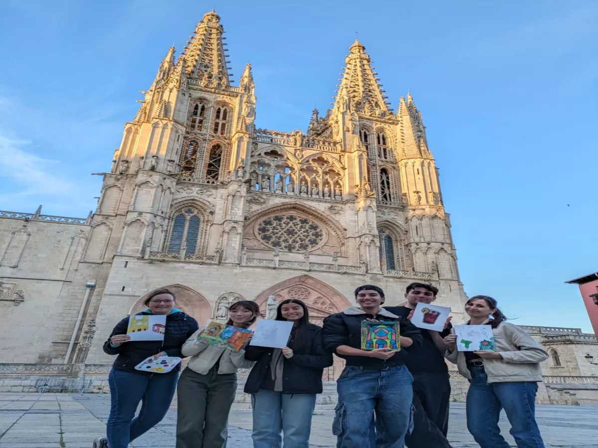 The students close to the cathedral with their paintings