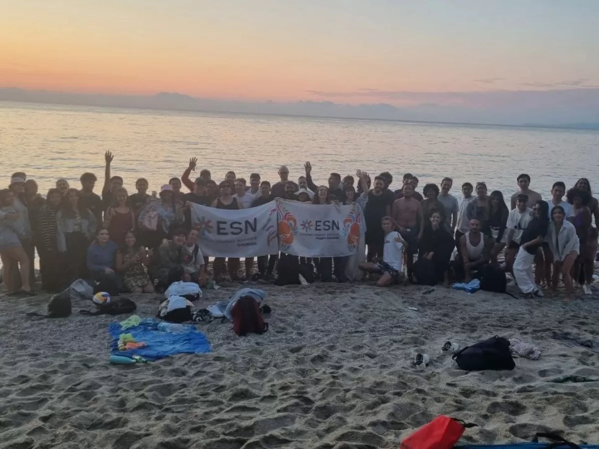 people standing for a photo at sunset