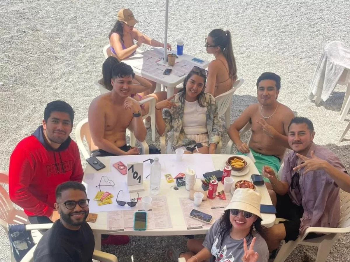 people around a table on the beach