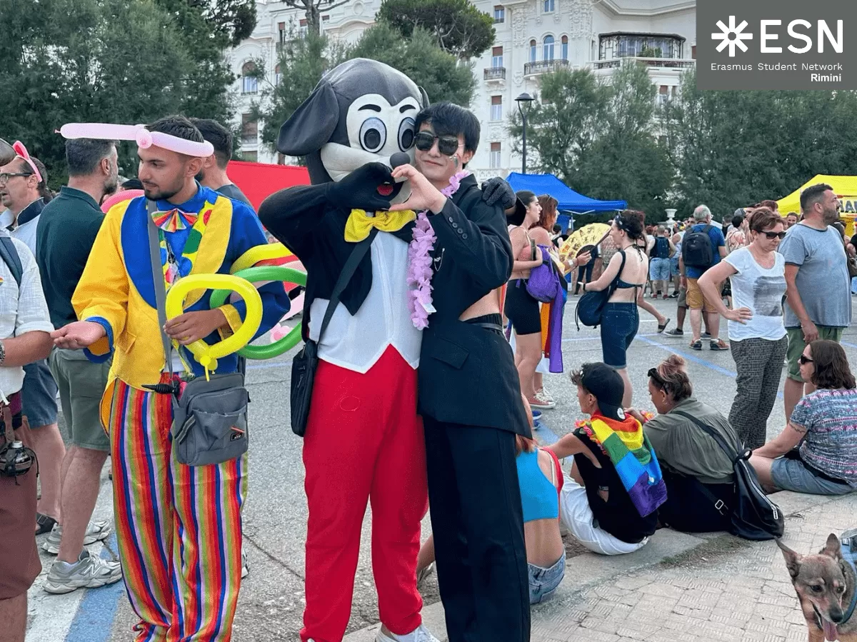 Boy hugging a men wearing a Mickey Mouse costume during the parade