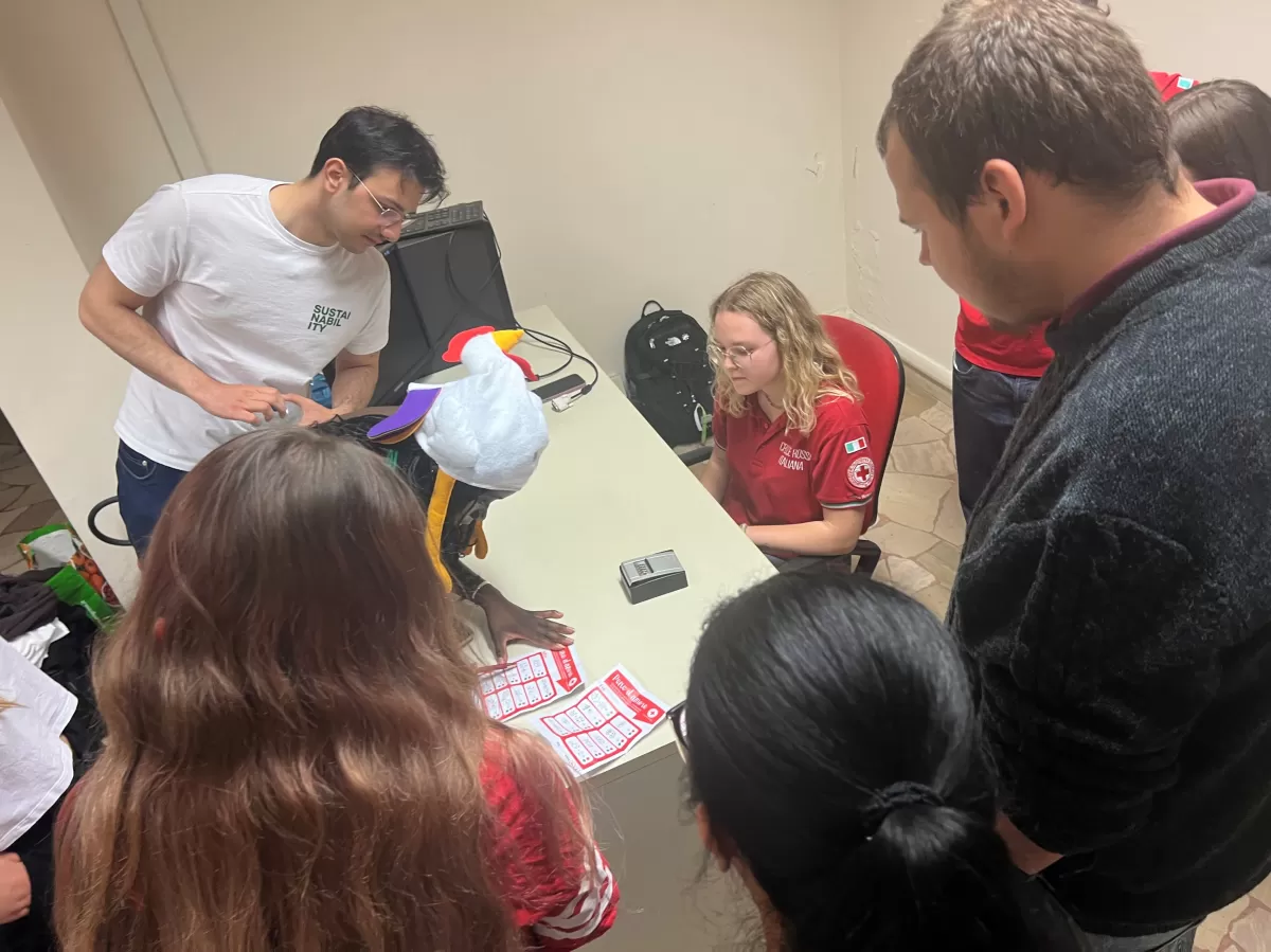 One of the groups sitting around a teble discussing a clue