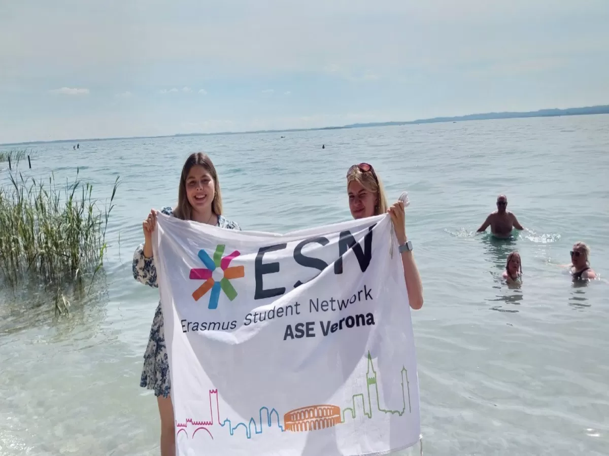 Two international students smiling while honlding the ESN flag