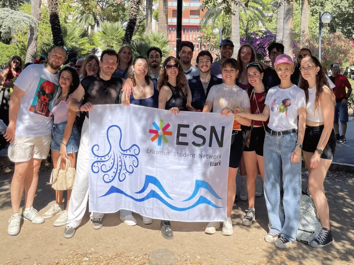 volunteers and erasmus students with section flag are pictured in a beautiful group photo before the start of the parade