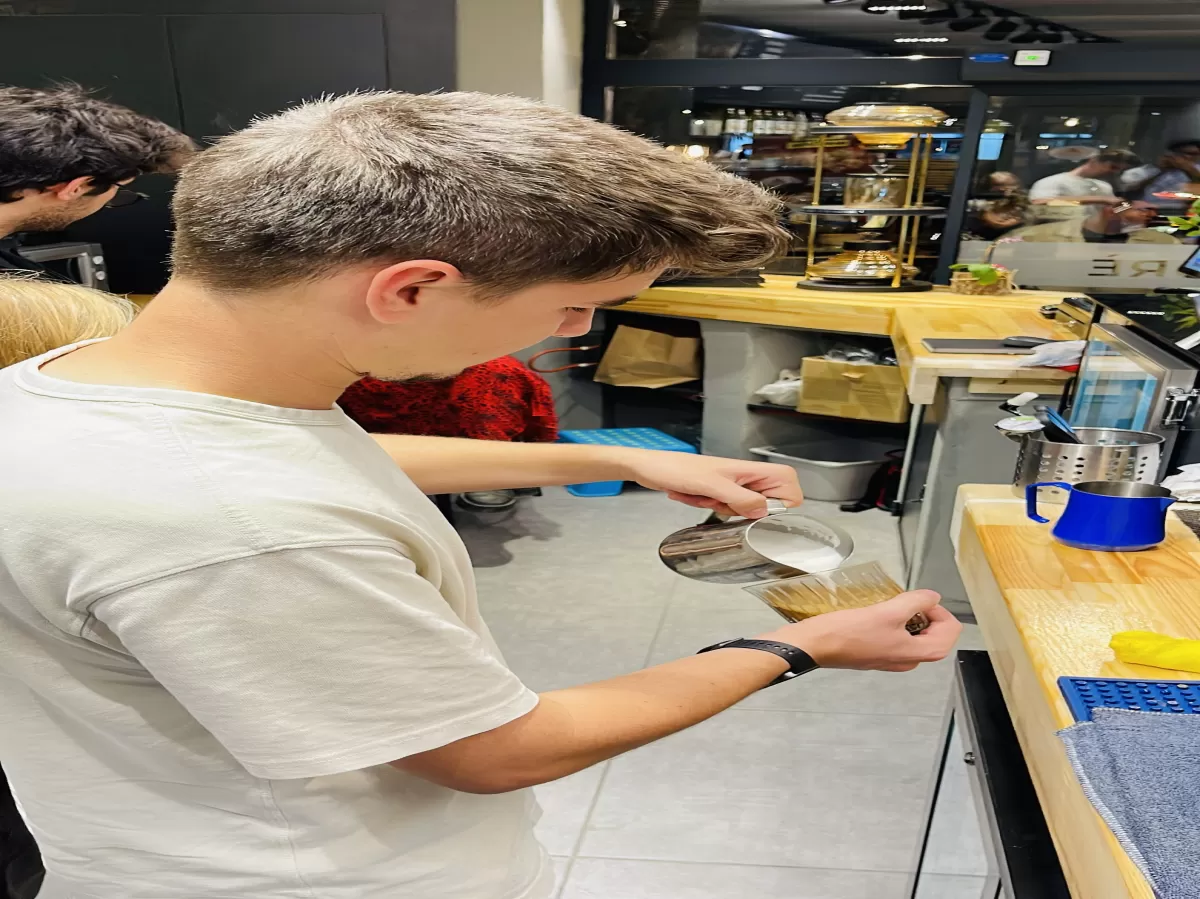 Student pouring his own coffee art.