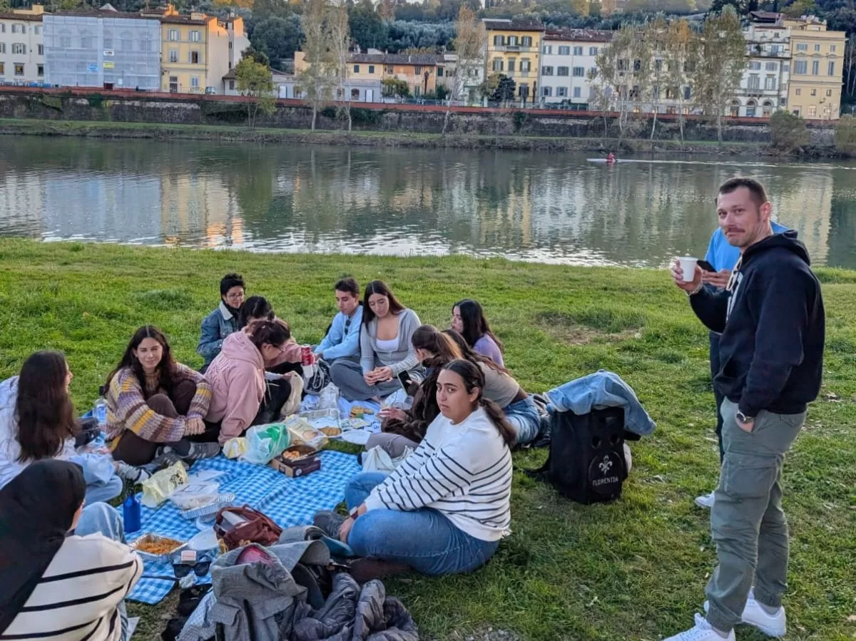 Students having a picnic on arno river