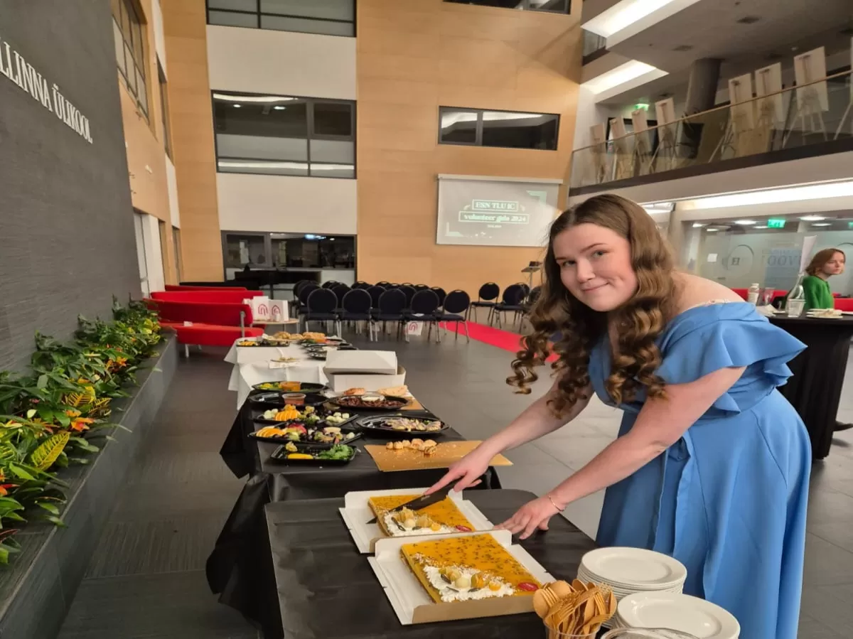 Vice President Hanna-Maria, also the event's organizer cutting up the cake