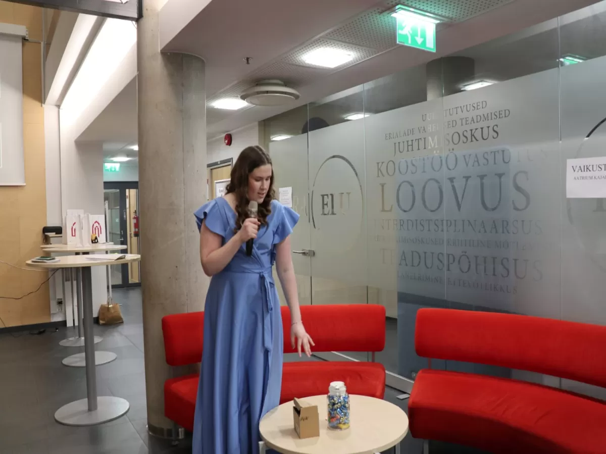 Event organizer introducing guess how many candies are in a jar game