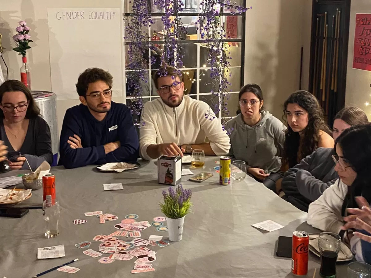 Group of international students talking inside a coffee shop