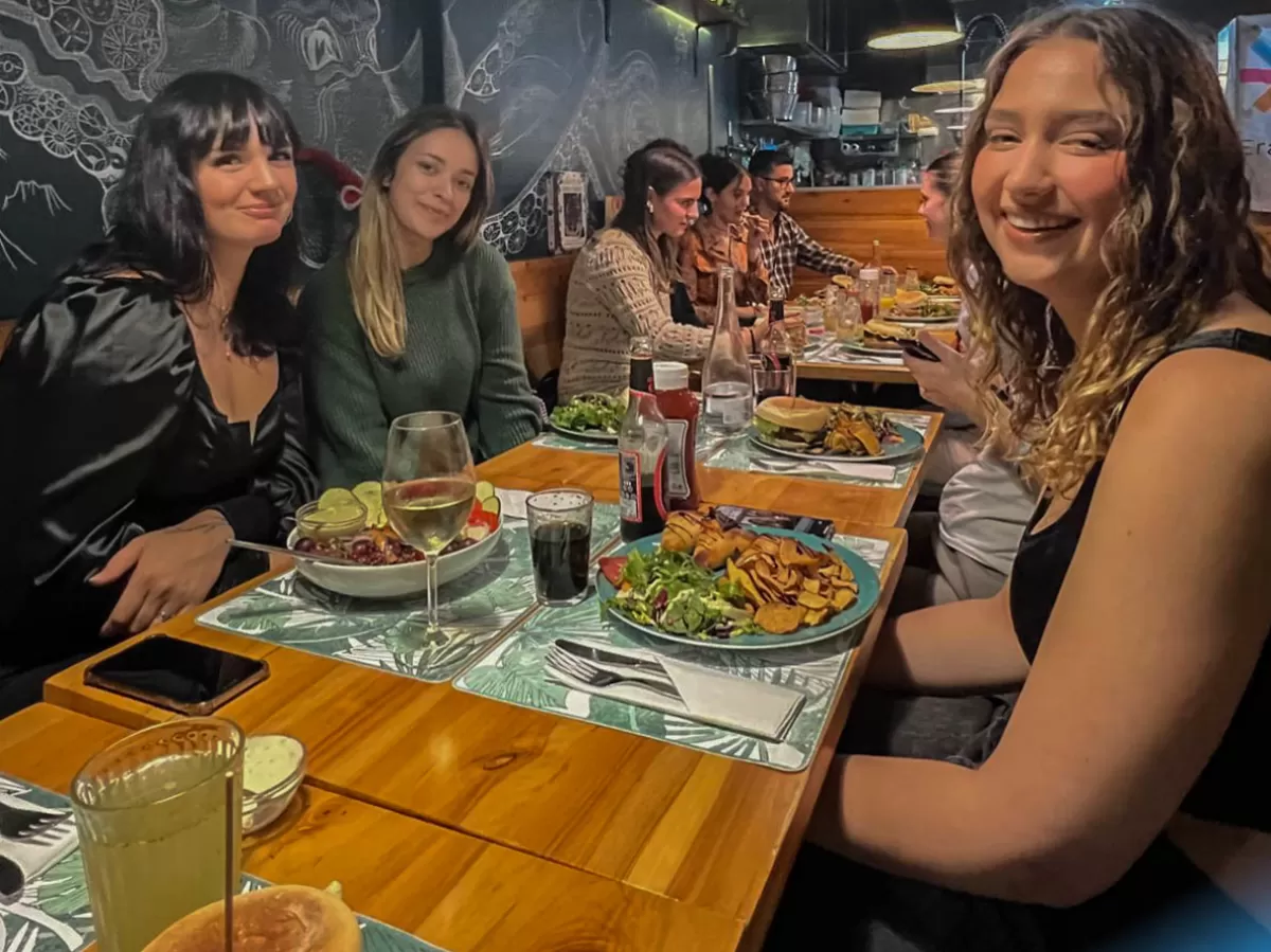Photo group of international students having a vegan dinner.