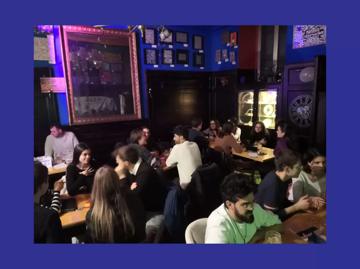 Participants sitting at the tables chatting