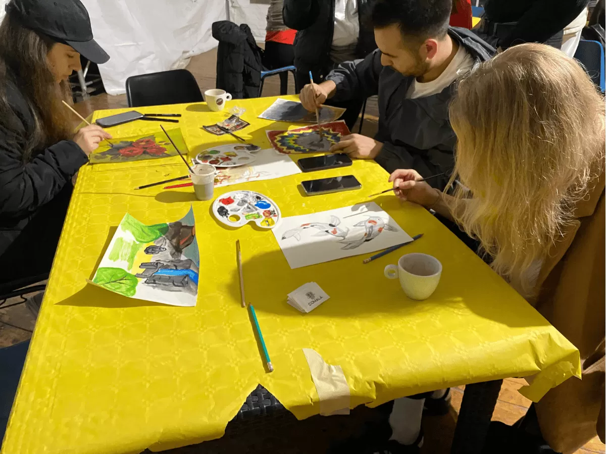 group of student using their non dominant hand to paint