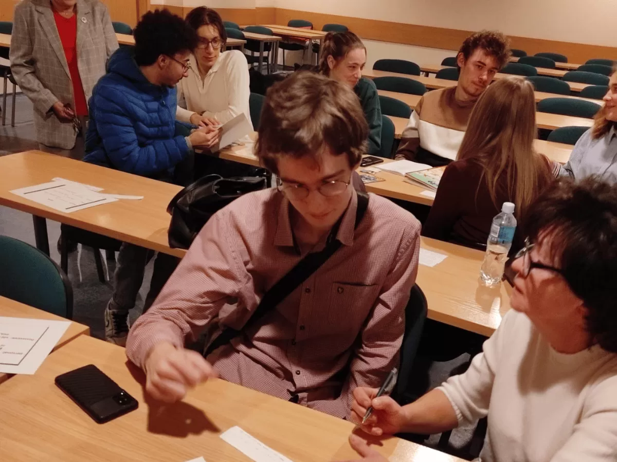 A group of students sitting by the table.
