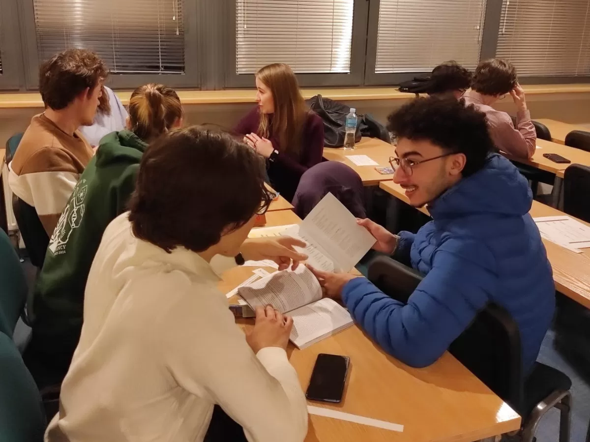 A group of students sitting by the table.
