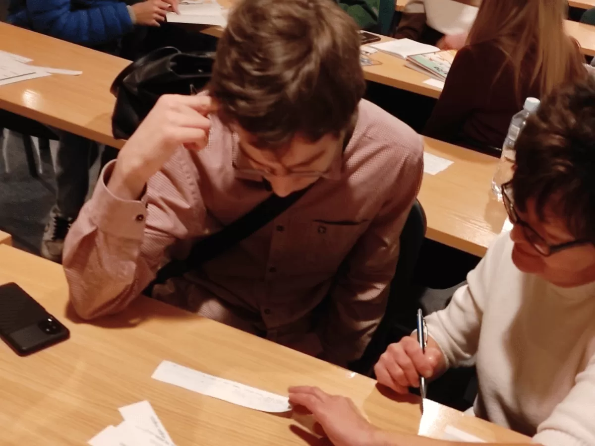 A group of students sitting by the table.