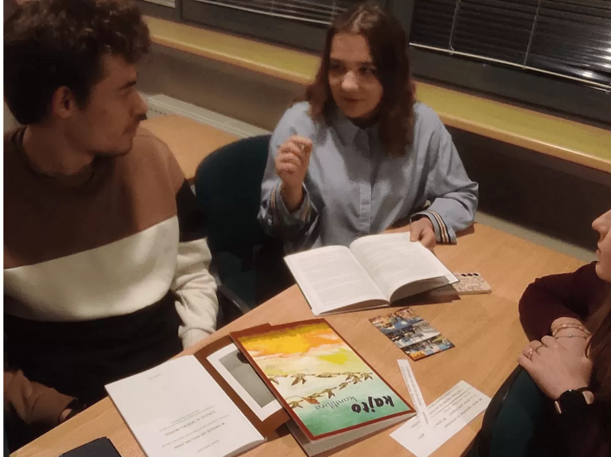 A group of students sitting by the table.