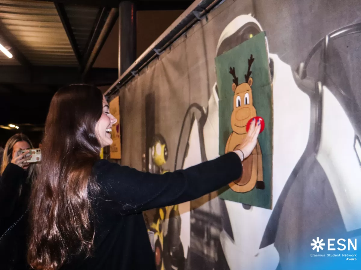 An international student playing a game with Rudolph's nose.