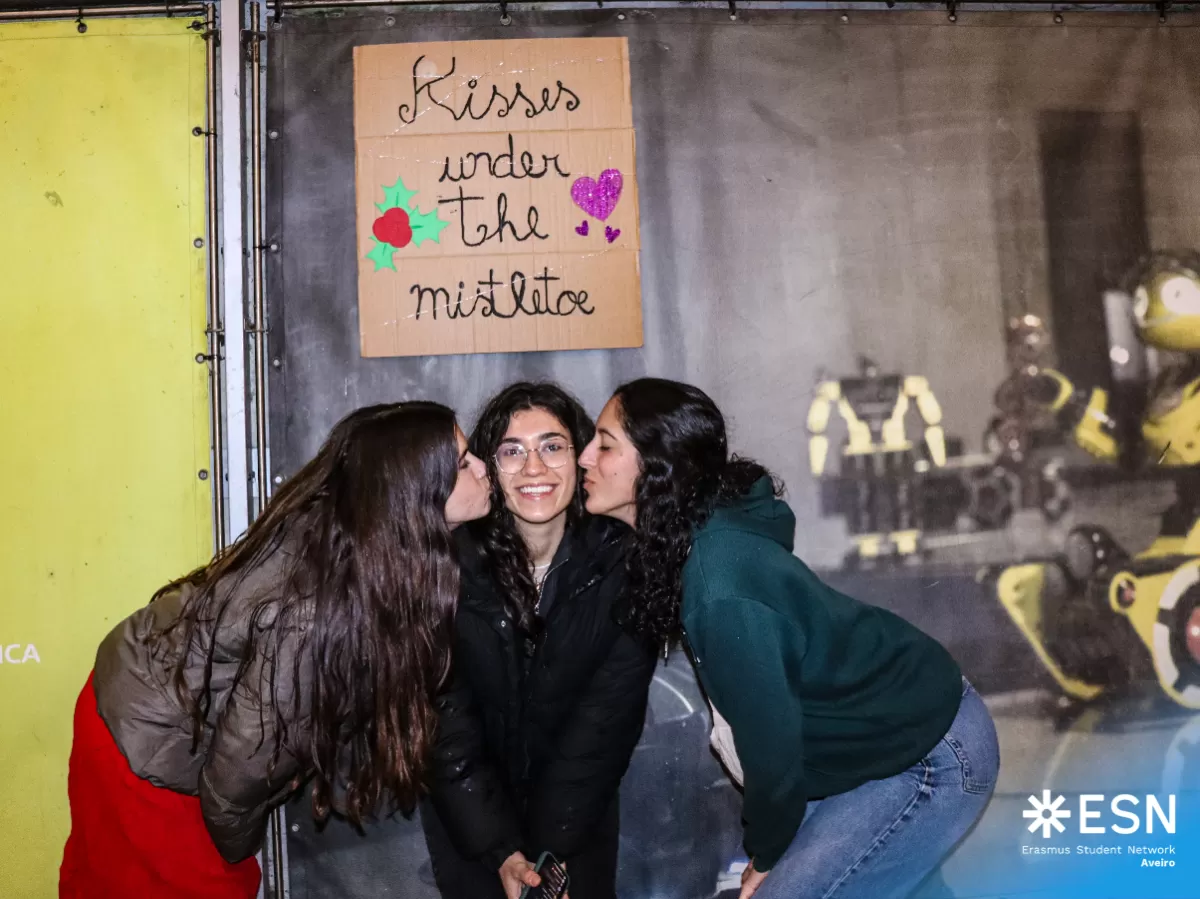 Volunteers sharing a kiss under the mistletoe.