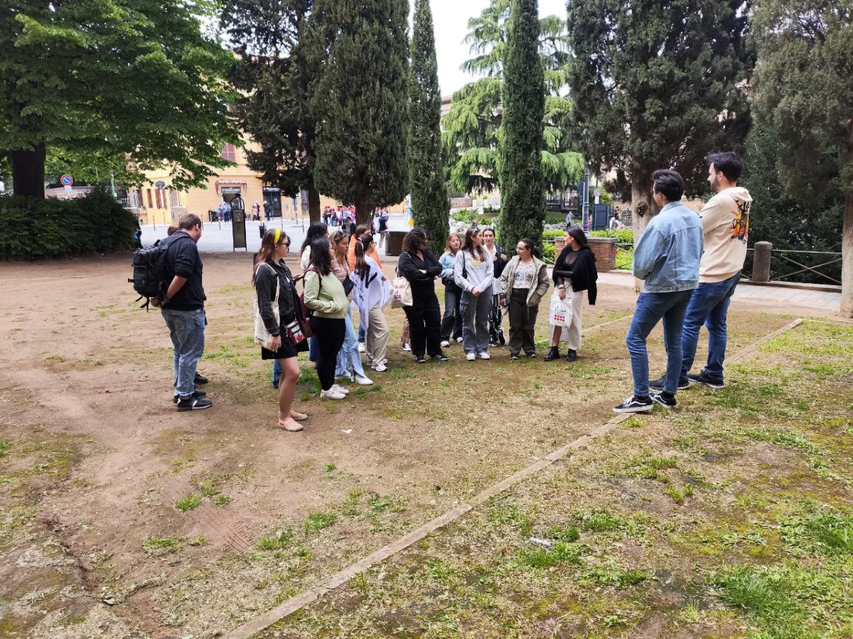 Erasmus students standing in a garden with ESN volunteers