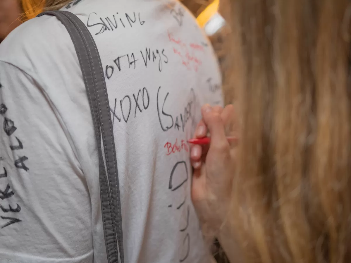 Signing a white t-shirt
