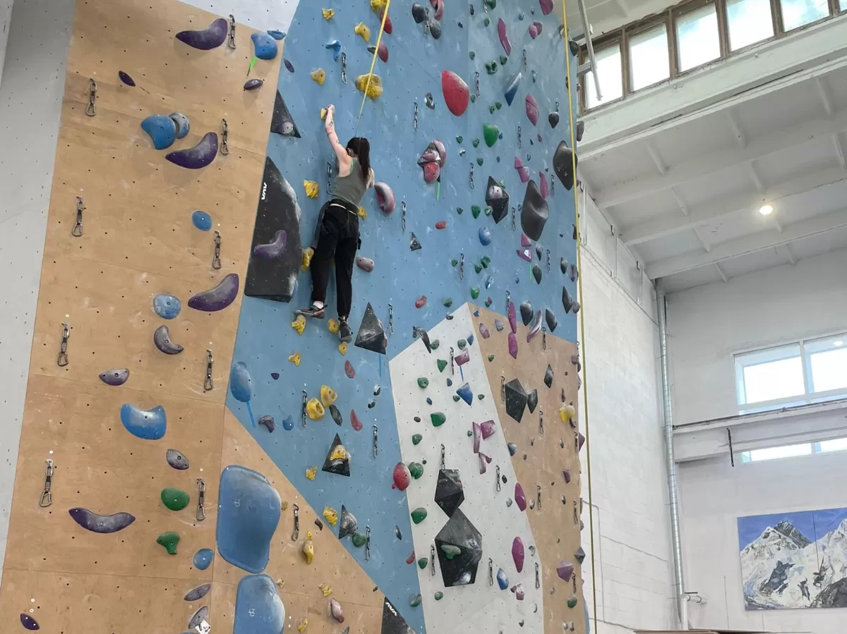 A person climbing up a wall