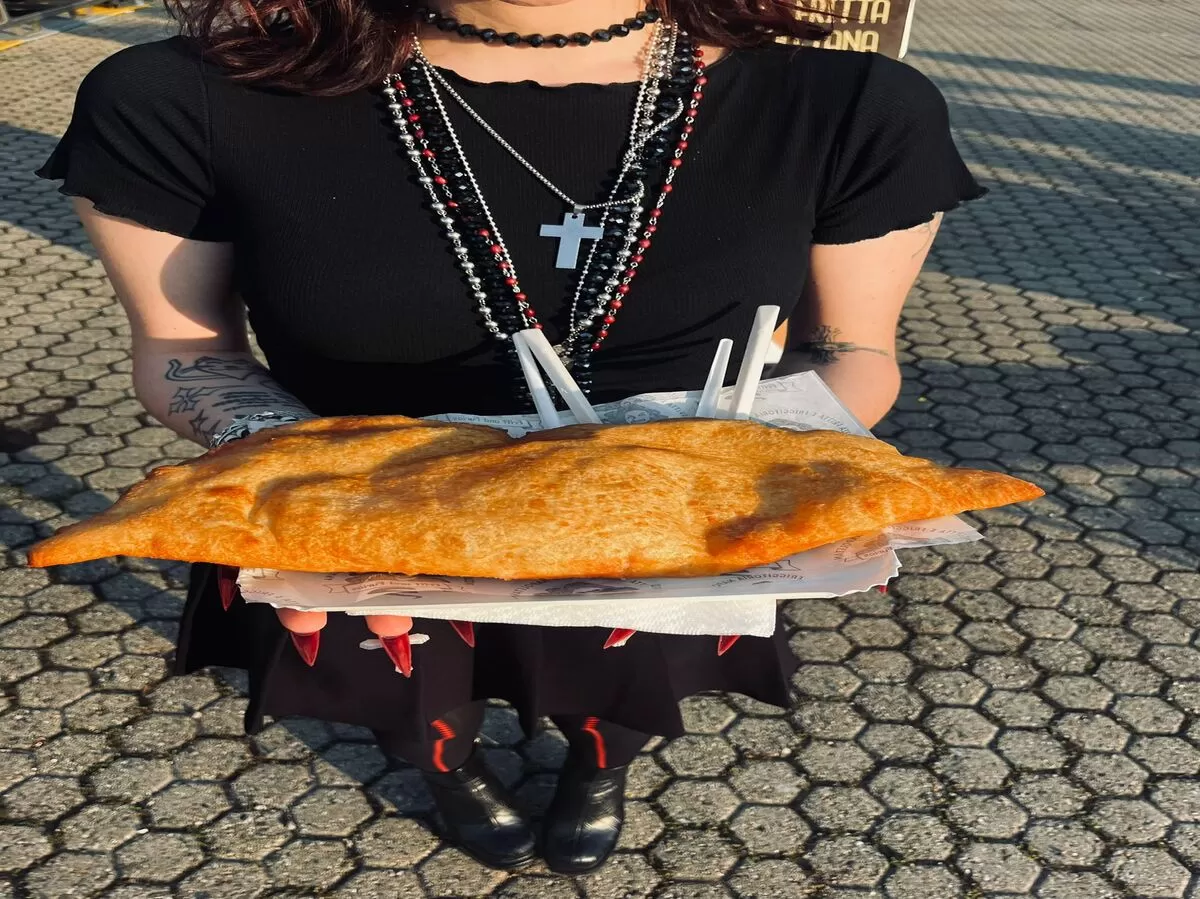 a participant holding a special dish from a specific country