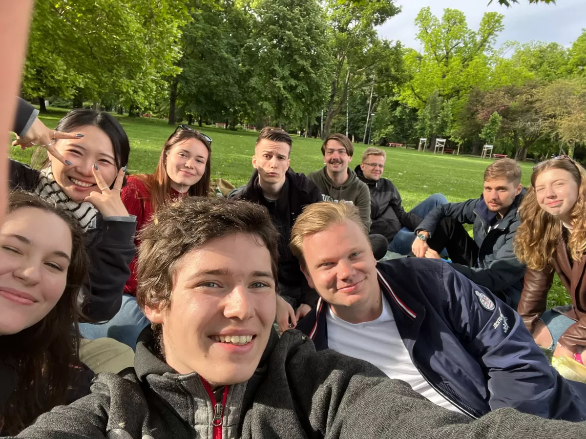 a group of people sitting in a park