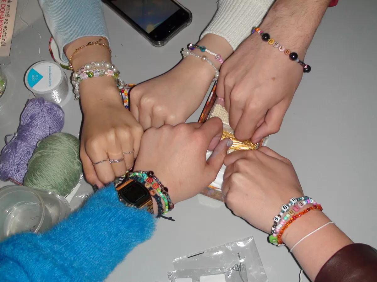 6 hands with bracelets on them