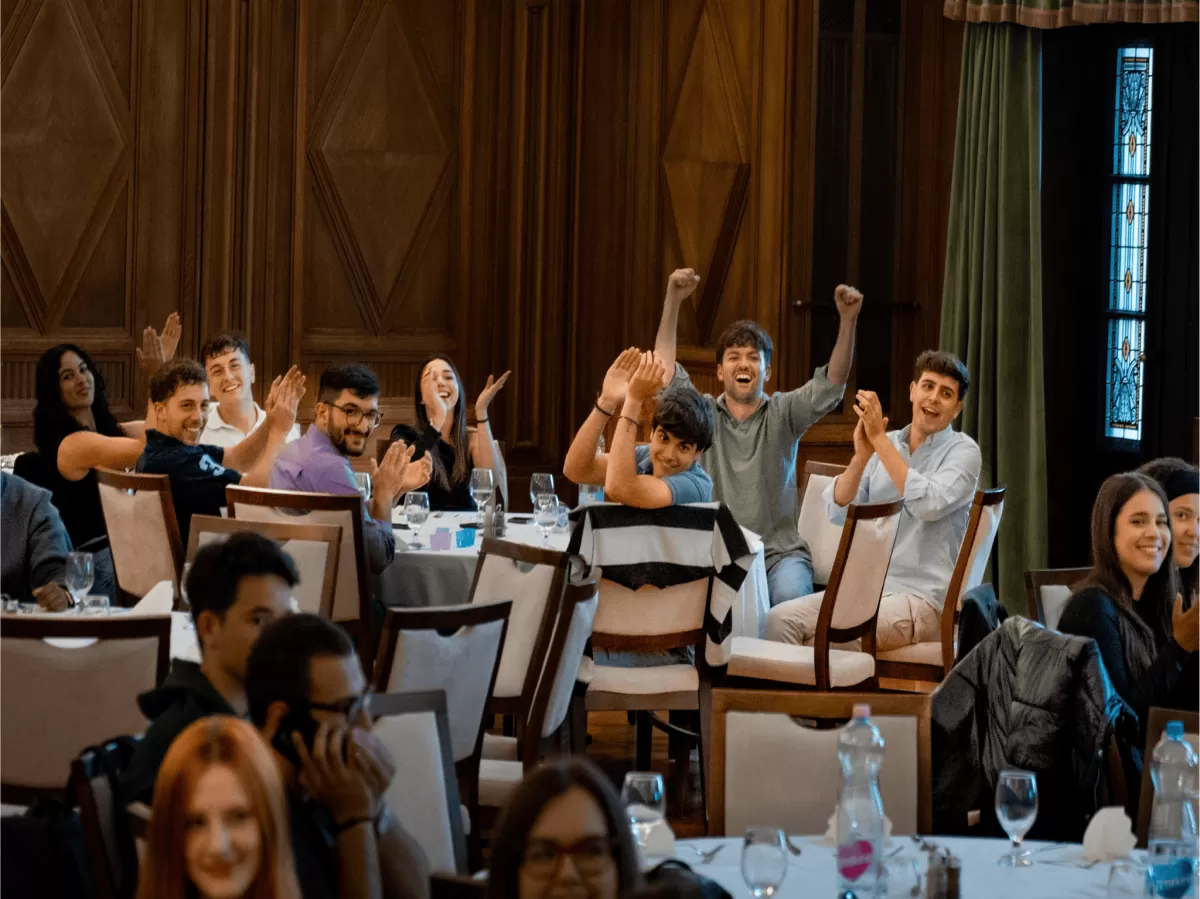 International students cheering for each other at a table