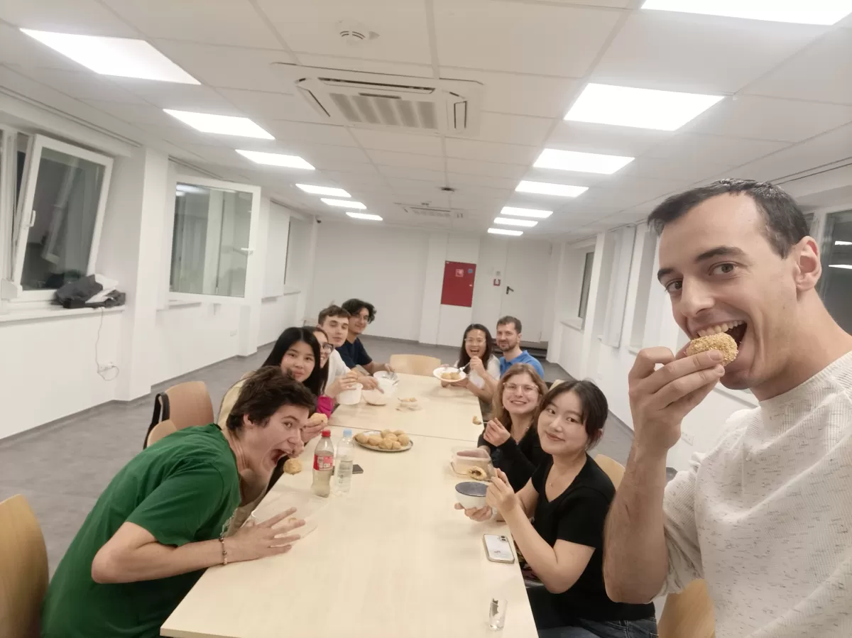 posing with the dumplings sitting next to the table in a large room