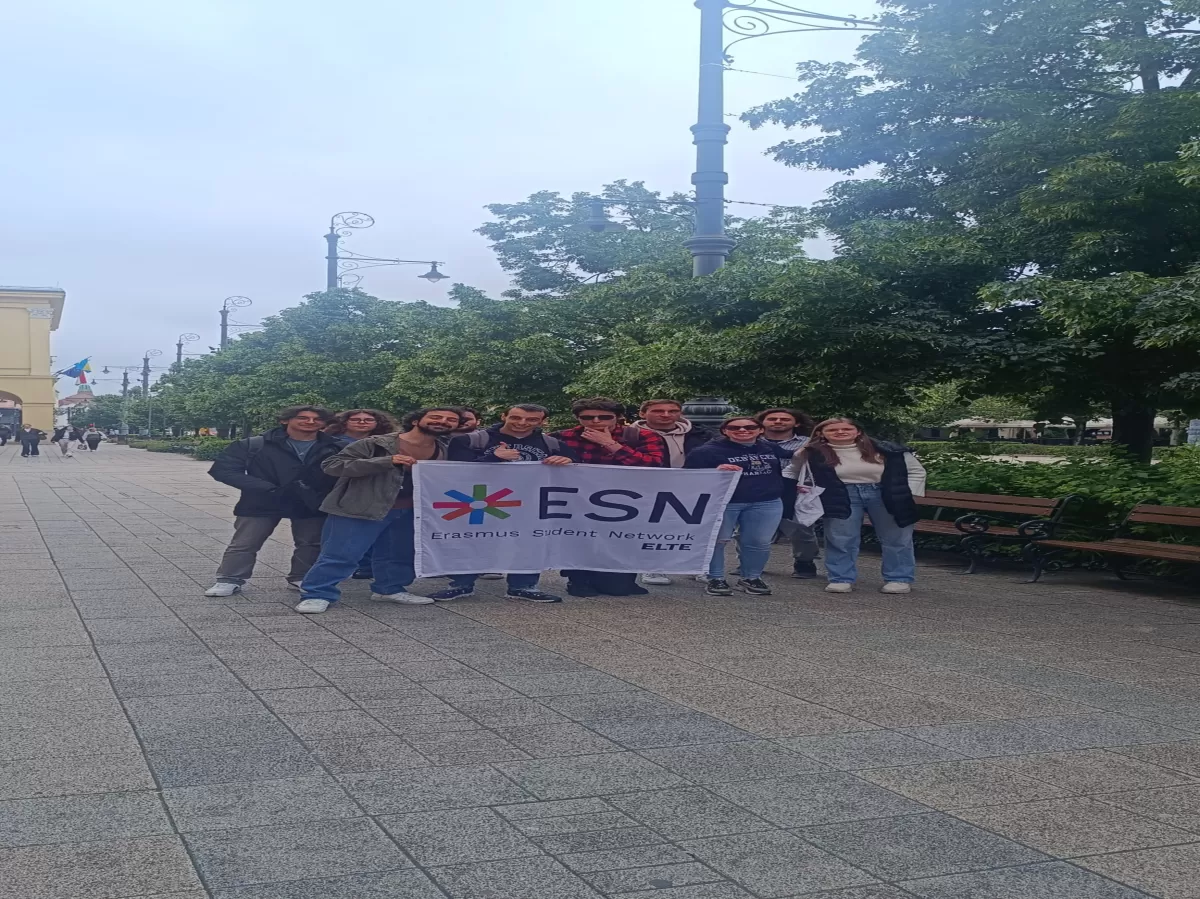 a group picture with an ESN ELTE flag in the main street of Debrecen