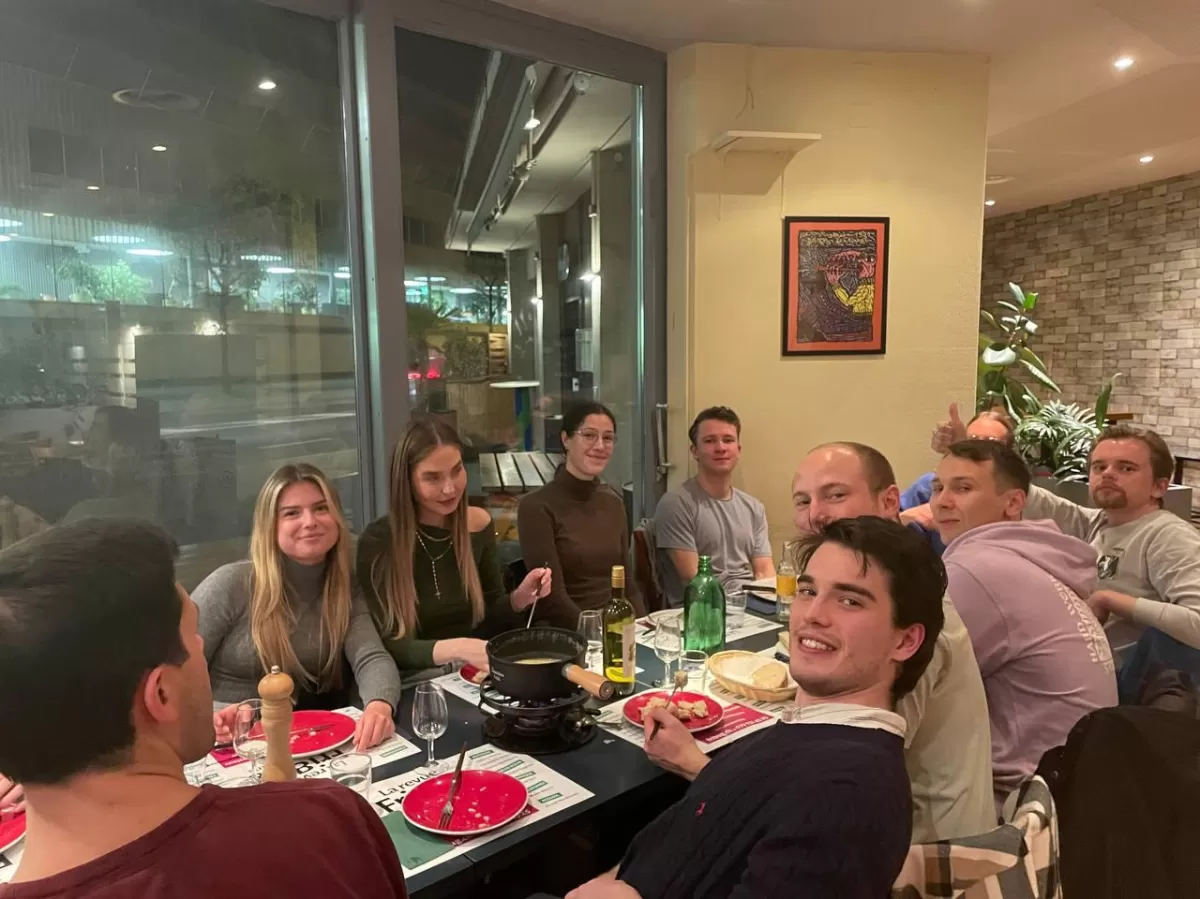 Picture representing some people at the table facing towards the camera