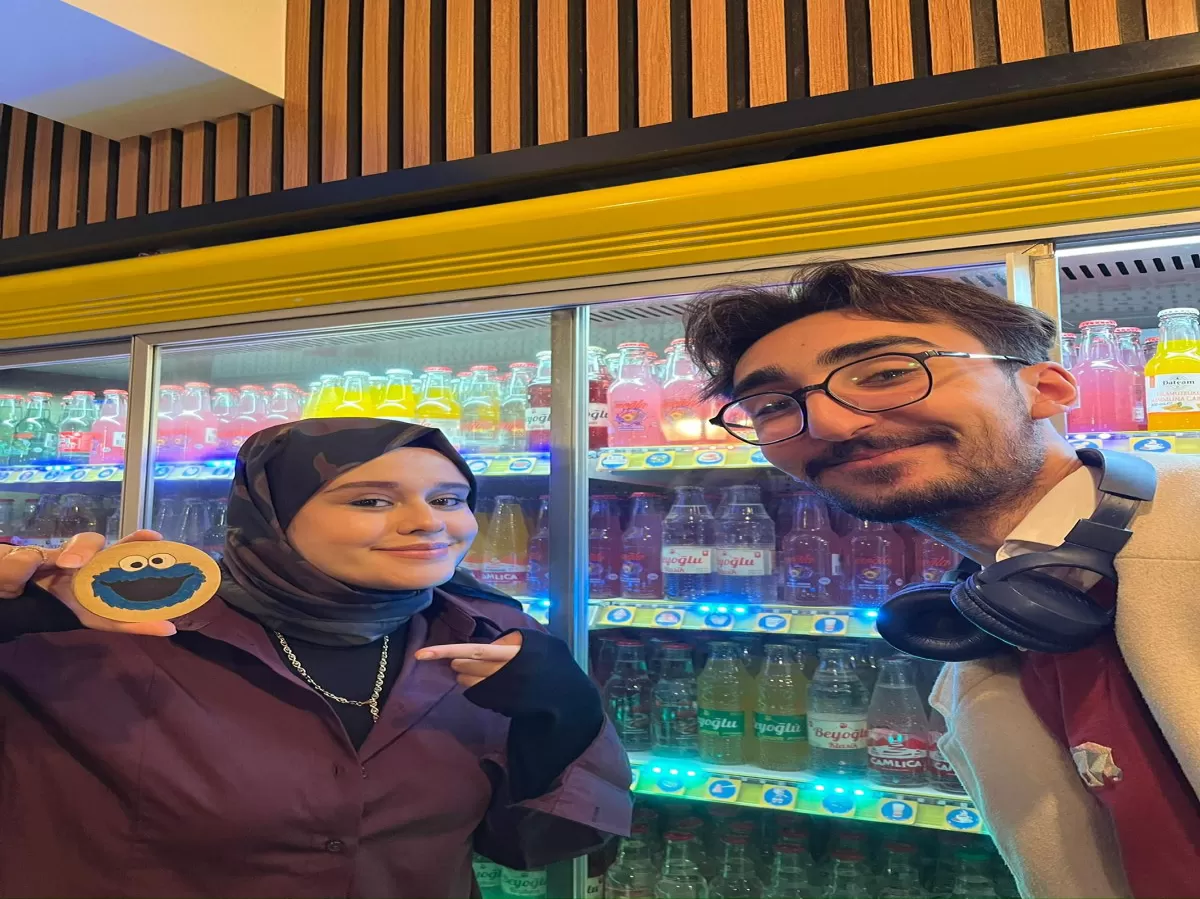 Participants holding a cookie monster plaque.