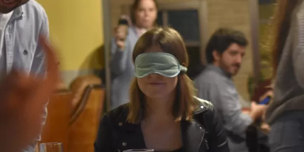 Blindfolded students having dinner