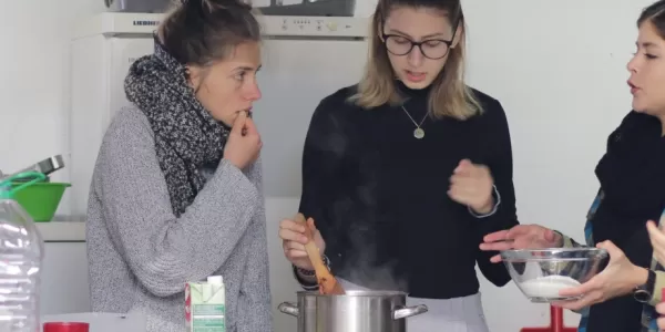 International students cooking vegan food together.