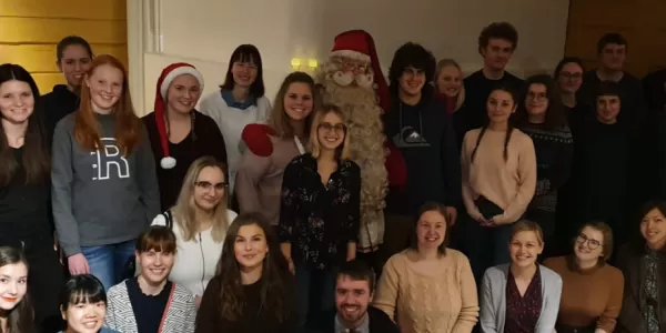 Happy locals and international students meeting Santa Claus in Friend Programme's pre-christmasy party.