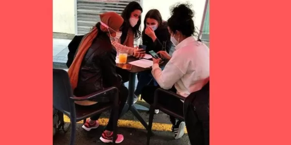 International students having a drink and speaking to each other during the activity