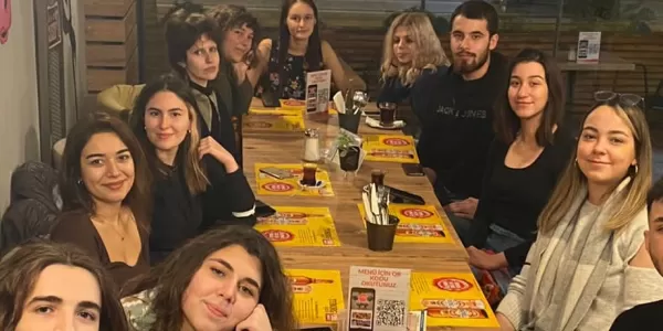 group of international and local students at a dinner