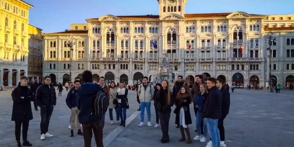 Guide in front of the group of incoming students on the Unity Square, main square of Trieste