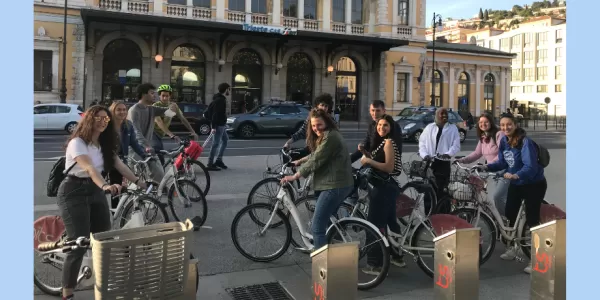 The picture shows a group of 4 boys and 7 girls on their bikes smiling at the camera.