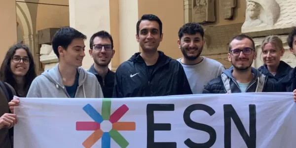 group of students posing with the ESN Modena flag