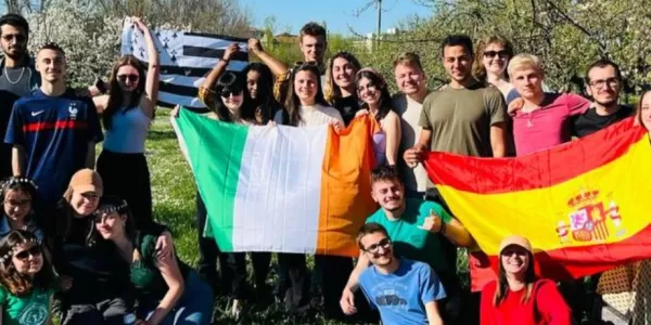 group of international students posing with the ESN Modena flag